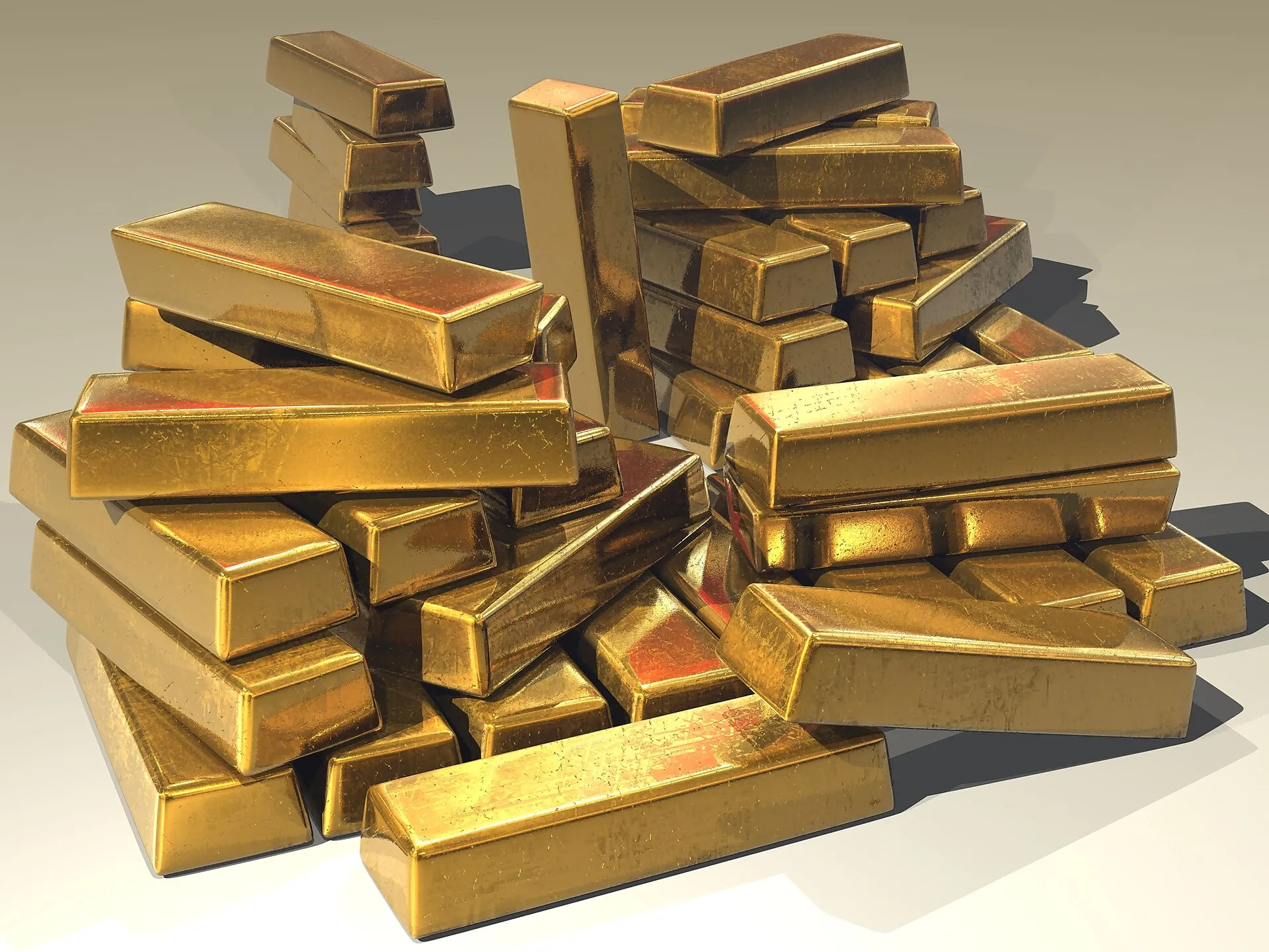 Stacked gold bullion bars on a white background