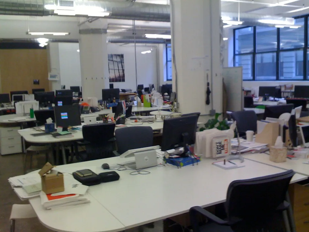 An empty modern office desk with city skyscrapers outside the window